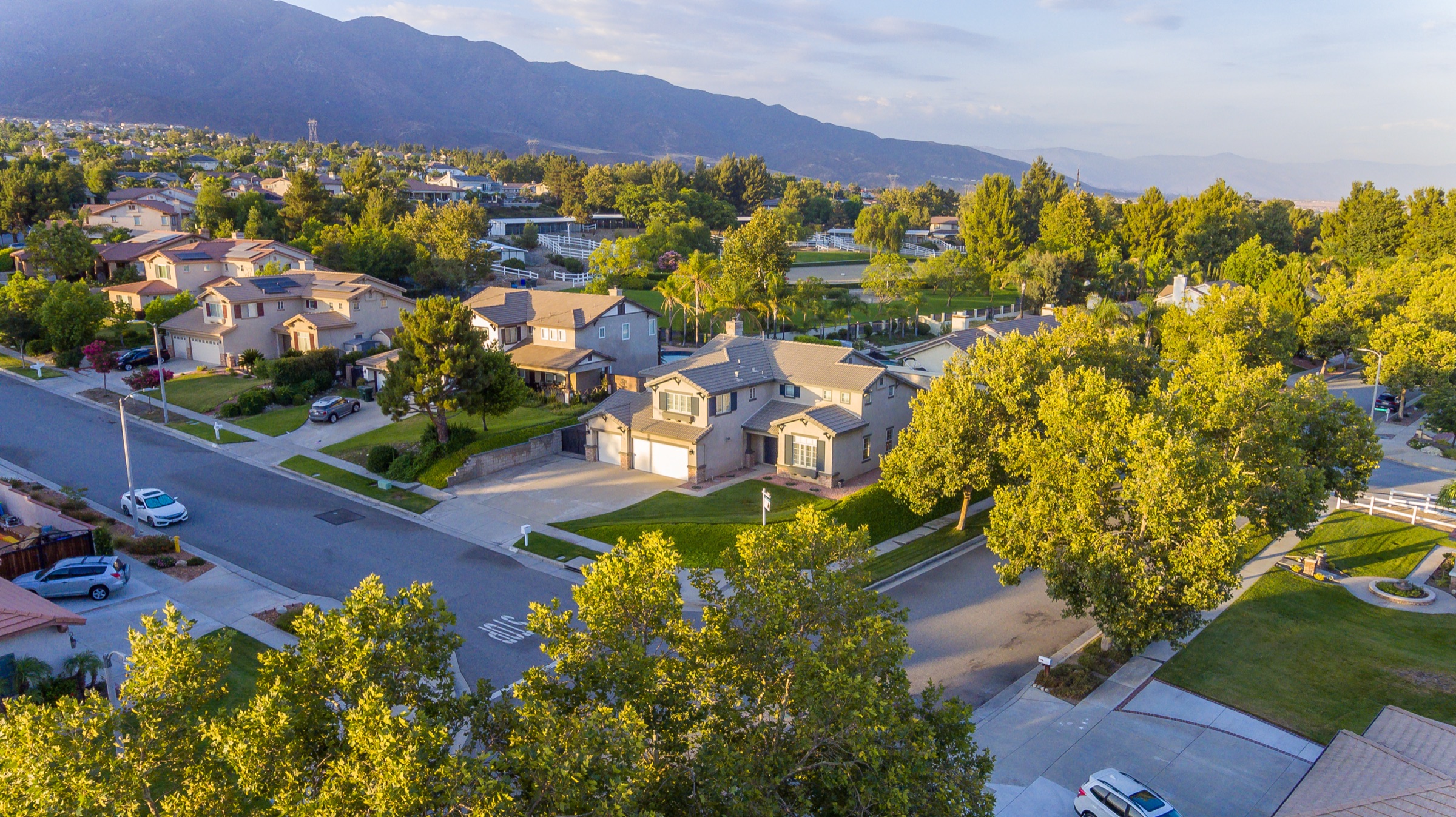 Aerial photograph of a High Desert neighborhood with the mountain range rising behind it